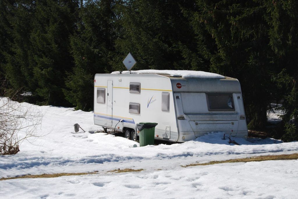 How to Keep RV Pipes From Freezing While Camping - Camper in snow