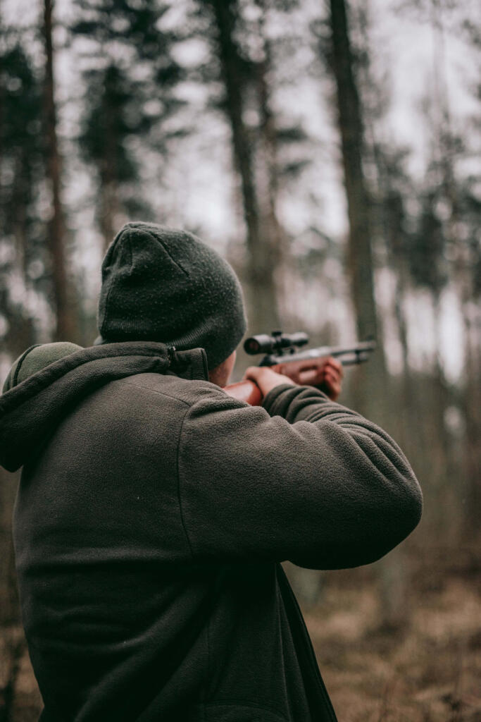 a hunter aiming at a target in the forest