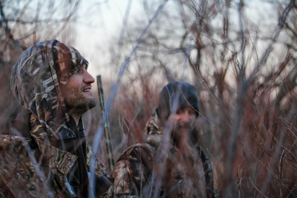 two hunters chatting in the bush
